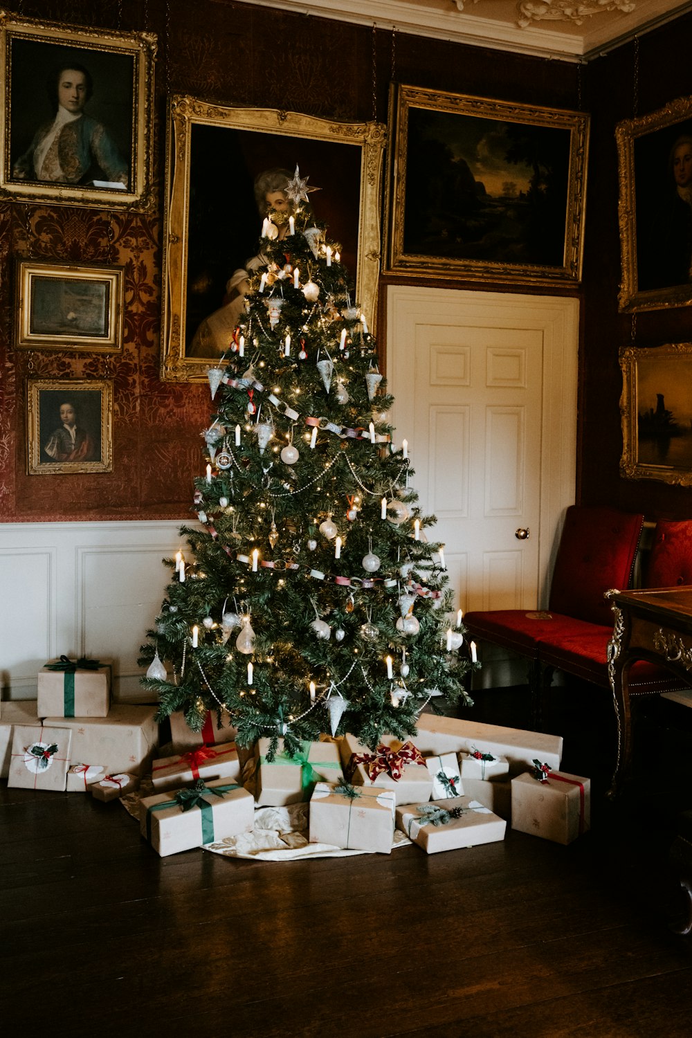 green Christmas tree with gift box inside room