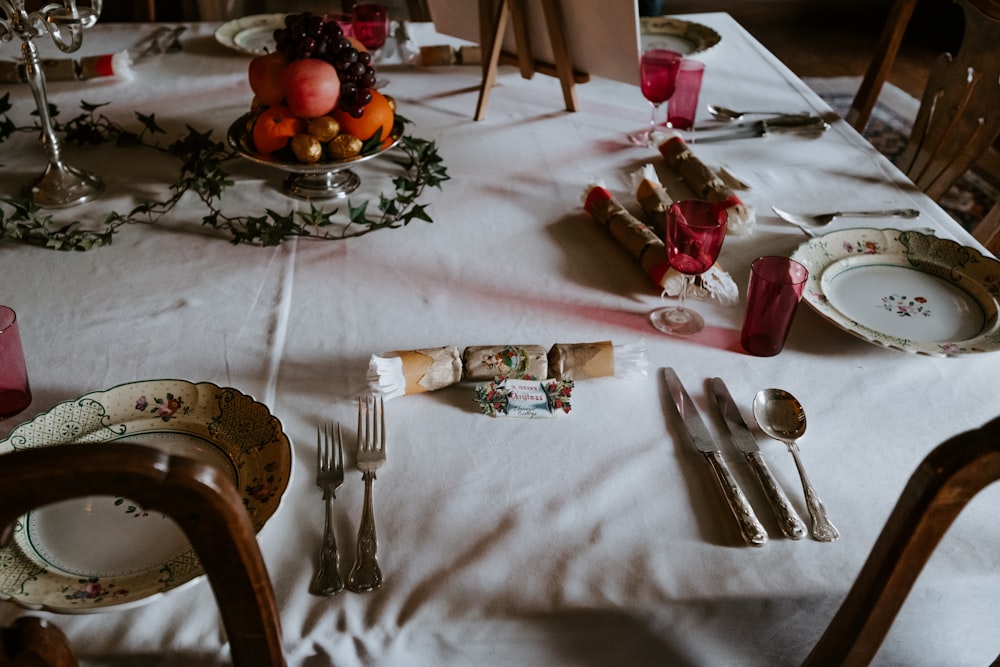 white floral ceramic plates and silver cutlery set