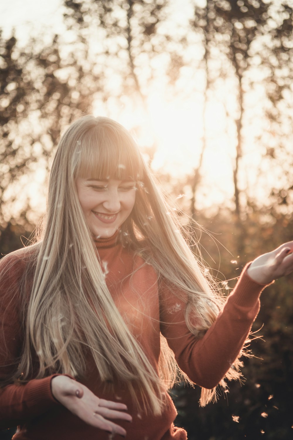 selective focus photography of smiling woman holding out hands