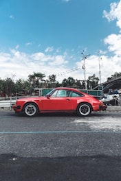 A classic sports car parked on a scenic road.
