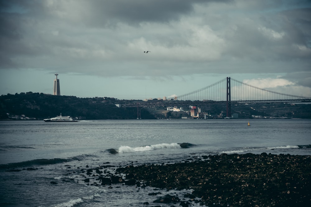 black suspension bridge over river