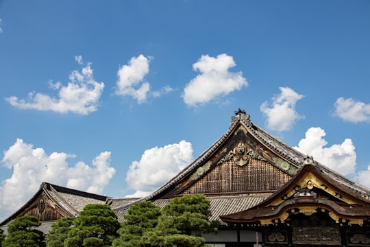 brown and white temple under blue sky during daytime in Nijō Castle Japan