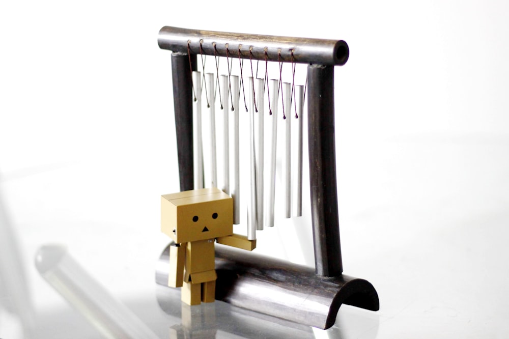 danbo standing beside wind chimes