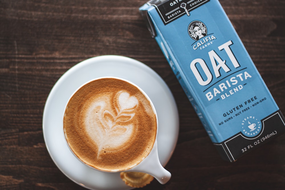cup of latte beside oat barista box