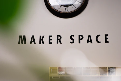 A creative maker space with tools, wood and craft supplies on shelves