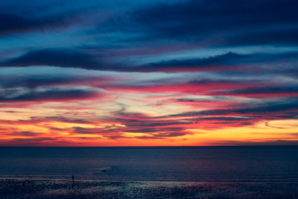 calm ocean under orange sky