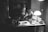 A consultant reviewing historical documents in an office setting, surrounded by artifacts and architectural plans.