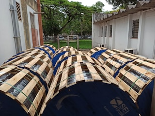 Various sizes of plastic reels displayed on factory shelves.