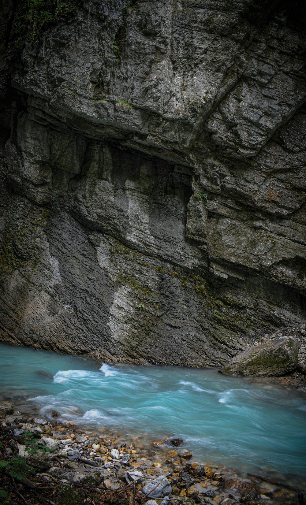 aerial photography of flowing river near rock formation