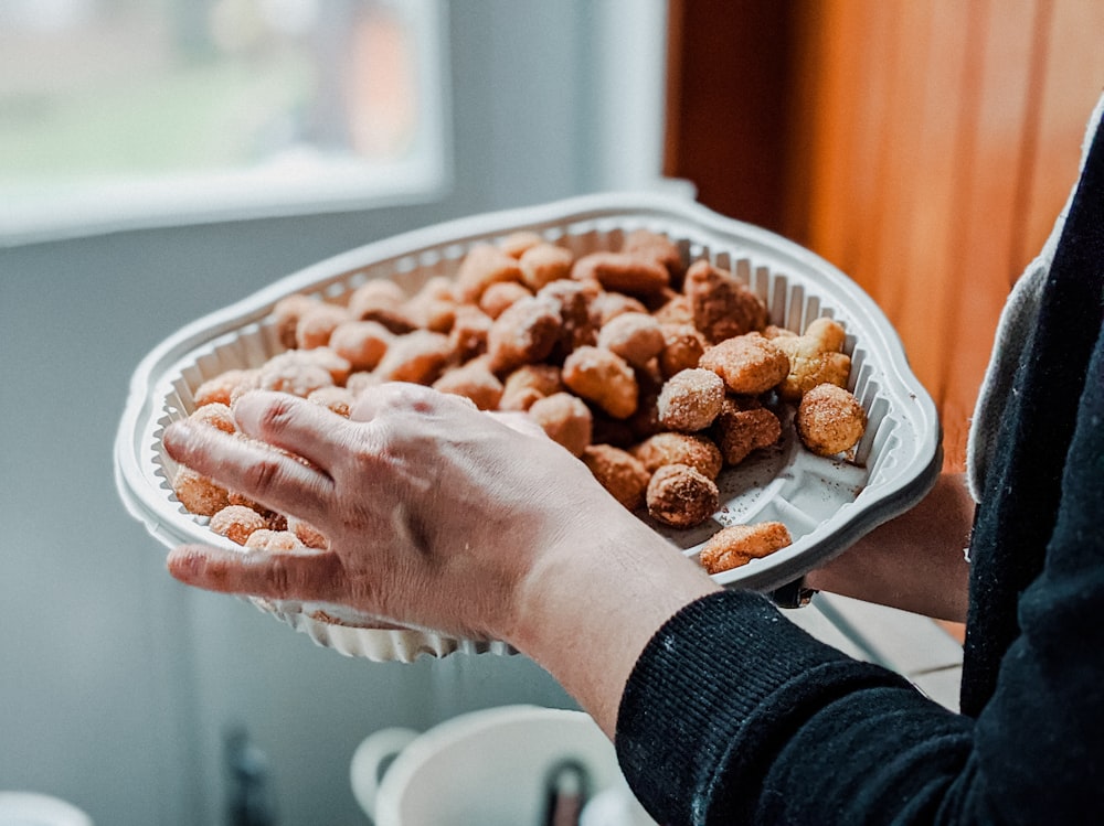 person holding tray with meatballs