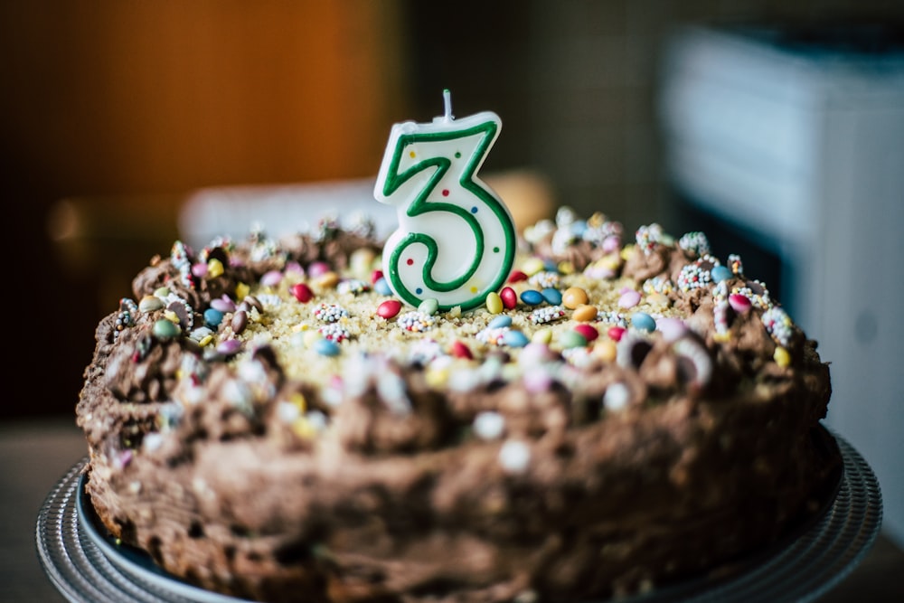 chocolate cake with number 3 candle on top