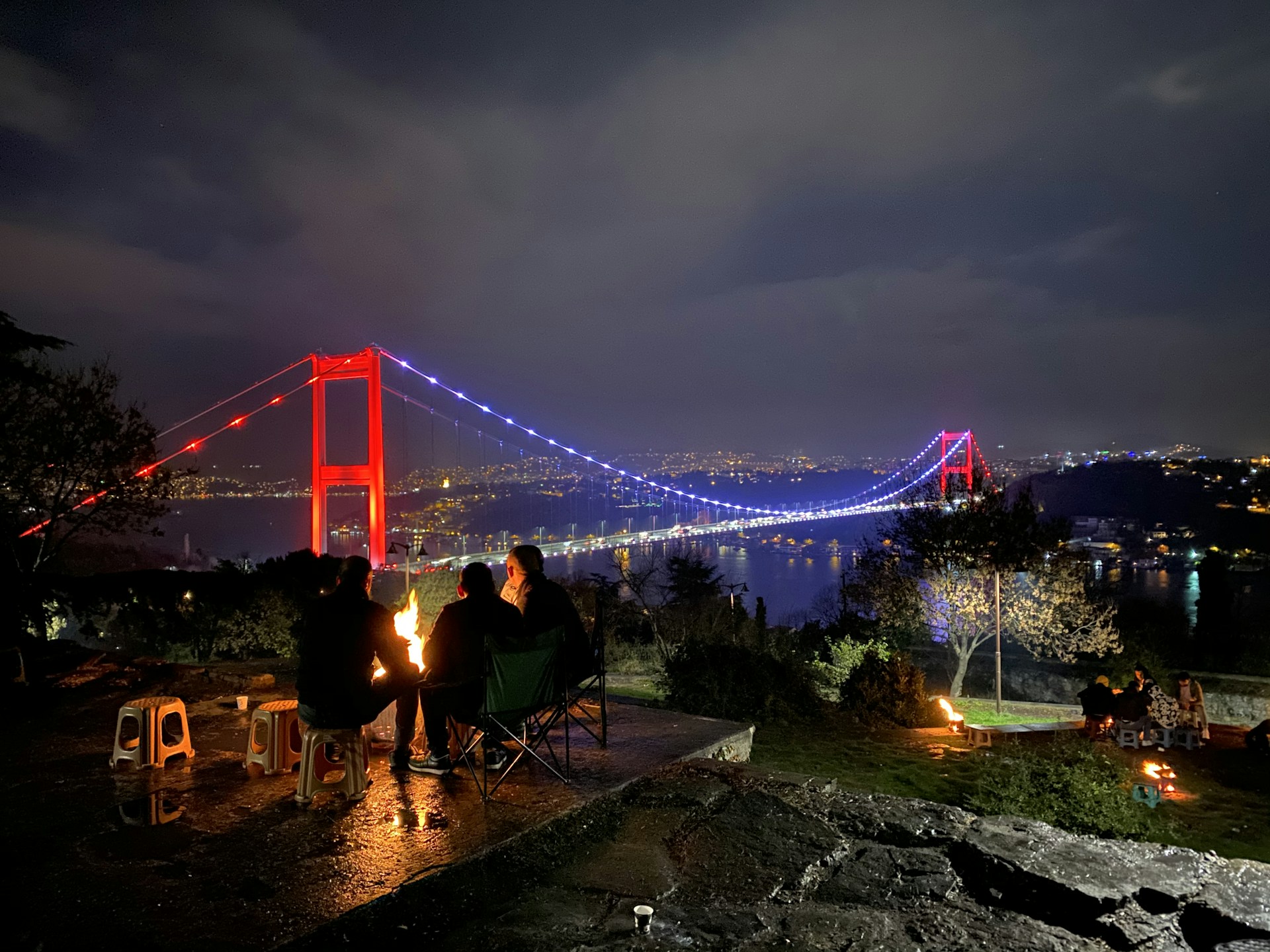 three person doing picnic near the Golden Gate bridge