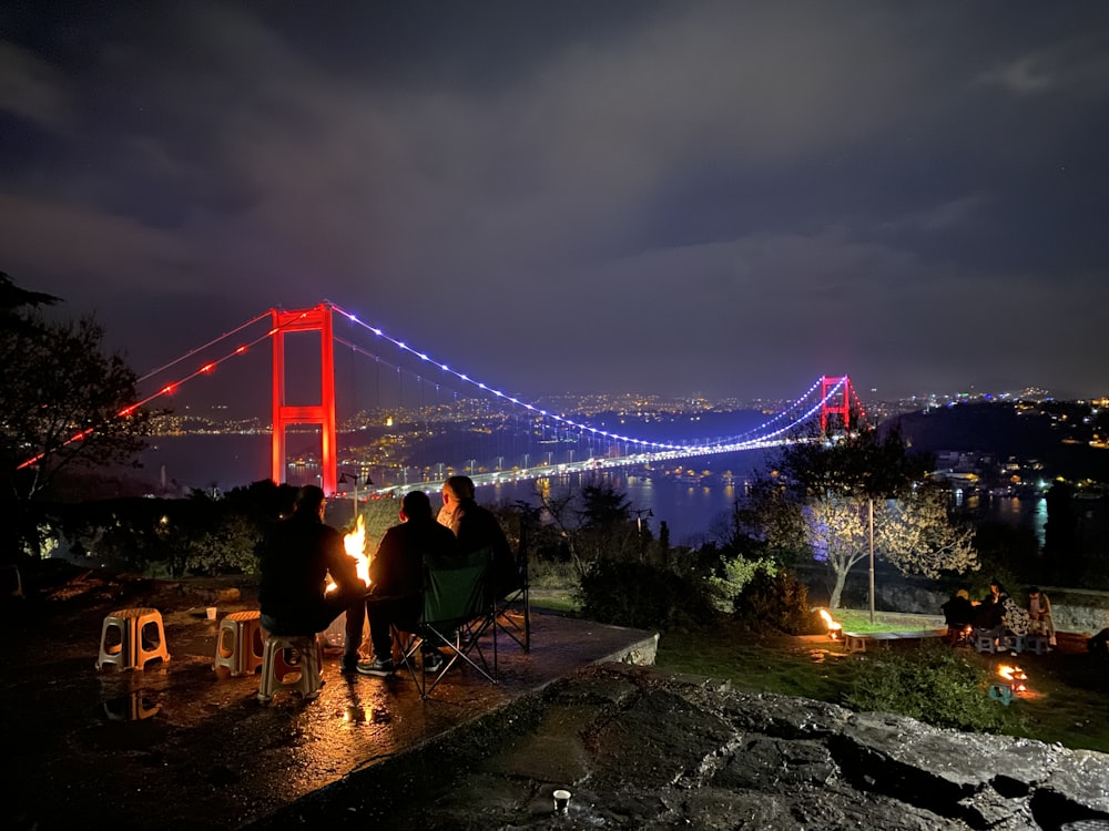 three person doing picnic near the Golden Gate bridge