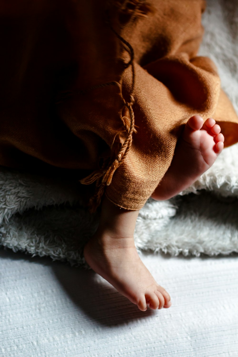 a baby laying on a blanket on top of a bed