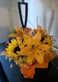 Bright and cheerful flower basket with sunflowers and lilies for celebrations.