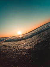 a person riding a surfboard on a wave in the ocean