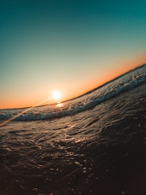 a person riding a surfboard on a wave in the ocean