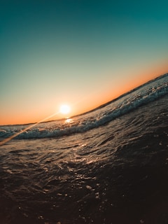 a person riding a surfboard on a wave in the ocean