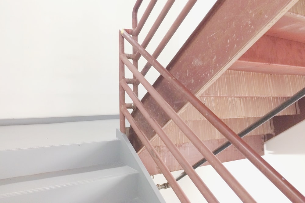 brown and white staircase with railing