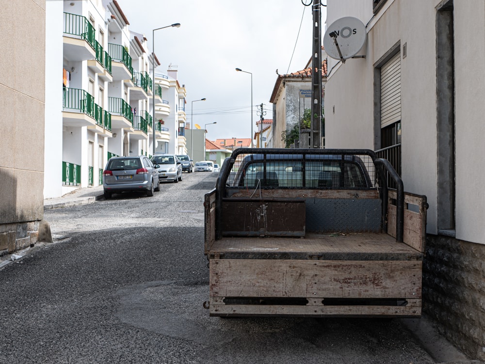 brown utility truck parking near white building during daytime