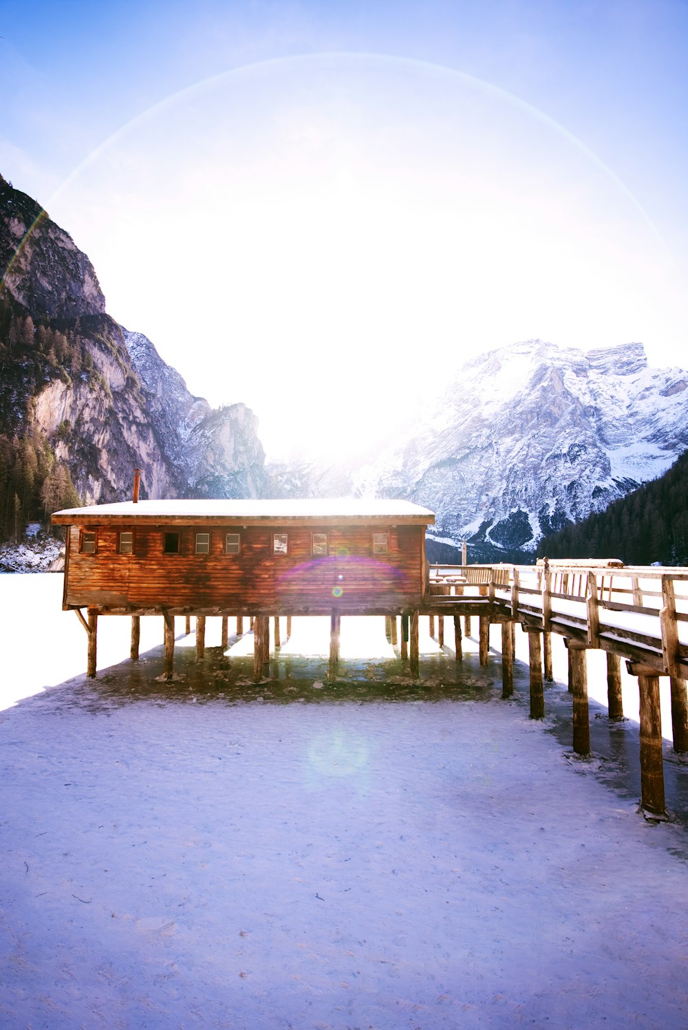 shallow focus photo of cabin near snow covered mountain