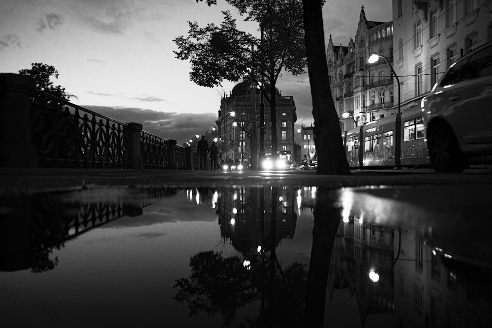 reflection of buildings and trees on body of water