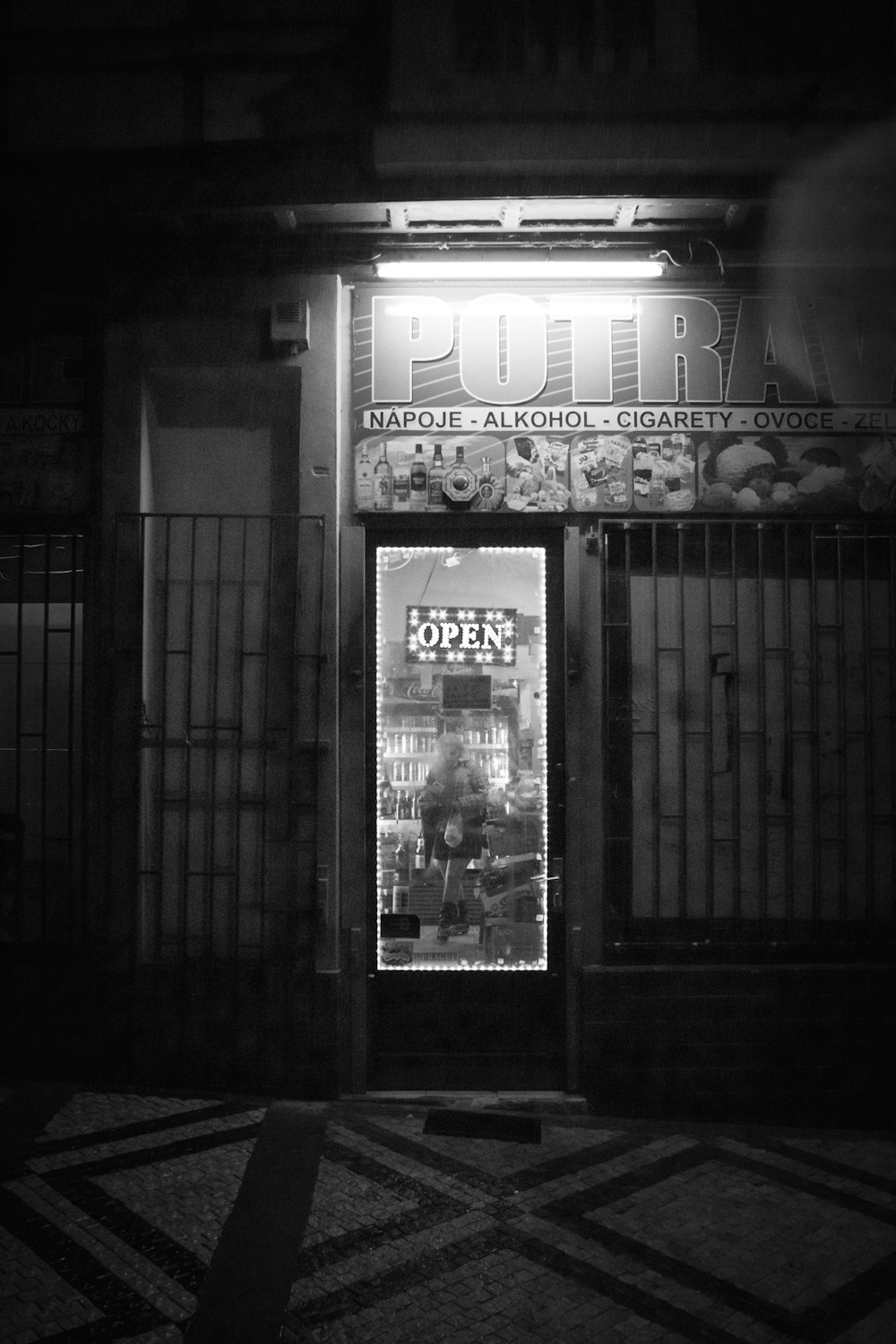 grayscale photography of door with Open sign