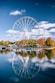 Ferris wheel beside trees near body of water