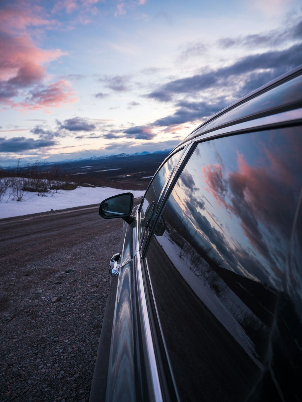 gray car parking under cloudy sky