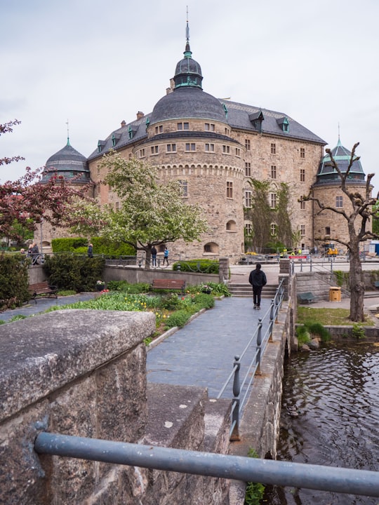 people walking near Orebro castle in Sweden in Örebro Castle Sweden