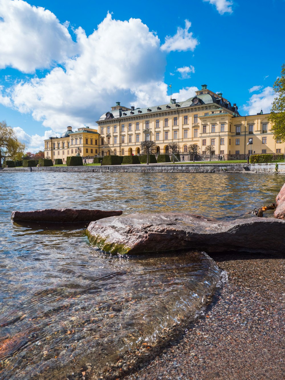 Drottningholm Palace in Sweden under white and blue sky