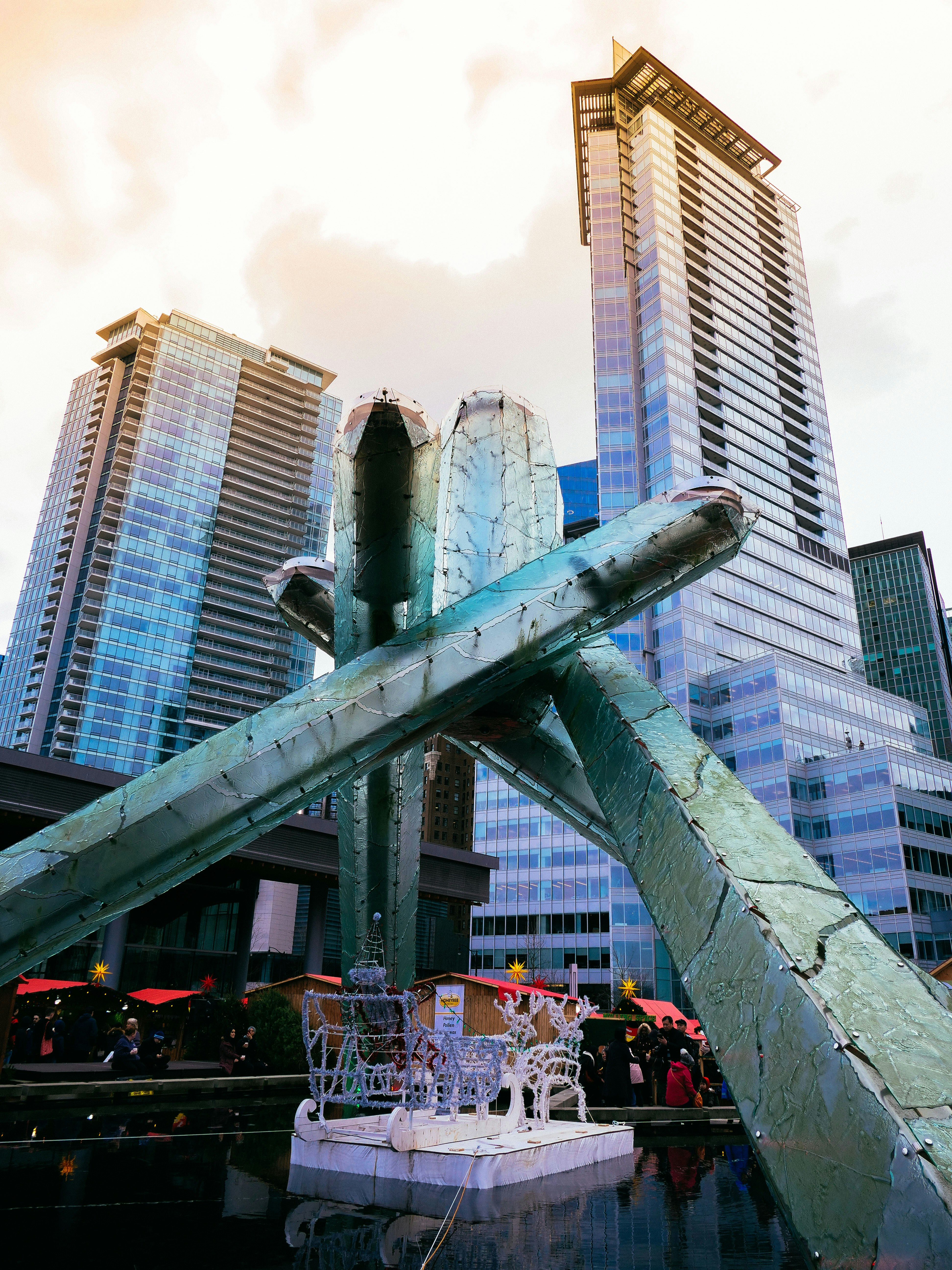 people near high-rise buildings under white sky