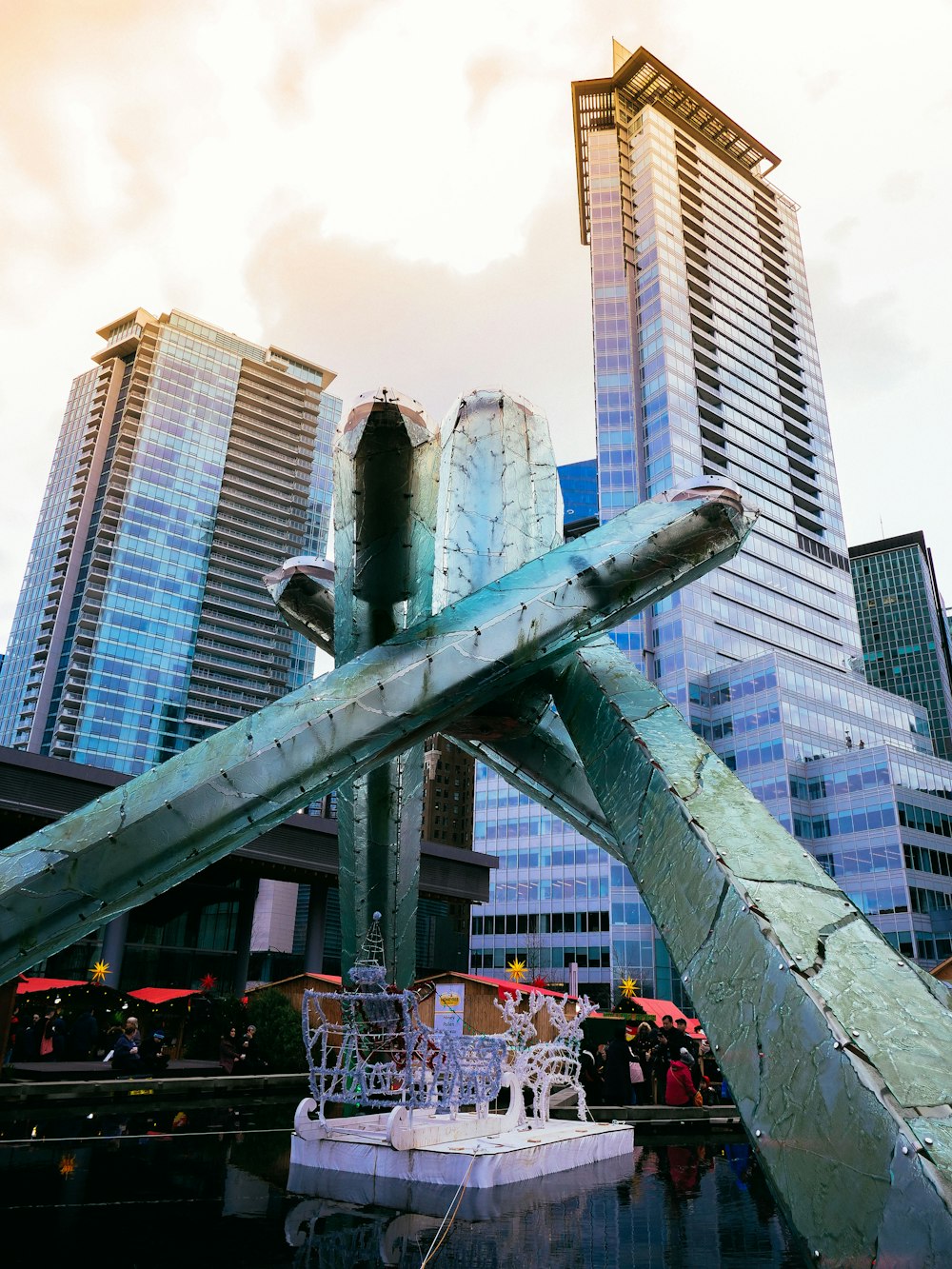 people near high-rise buildings under white sky