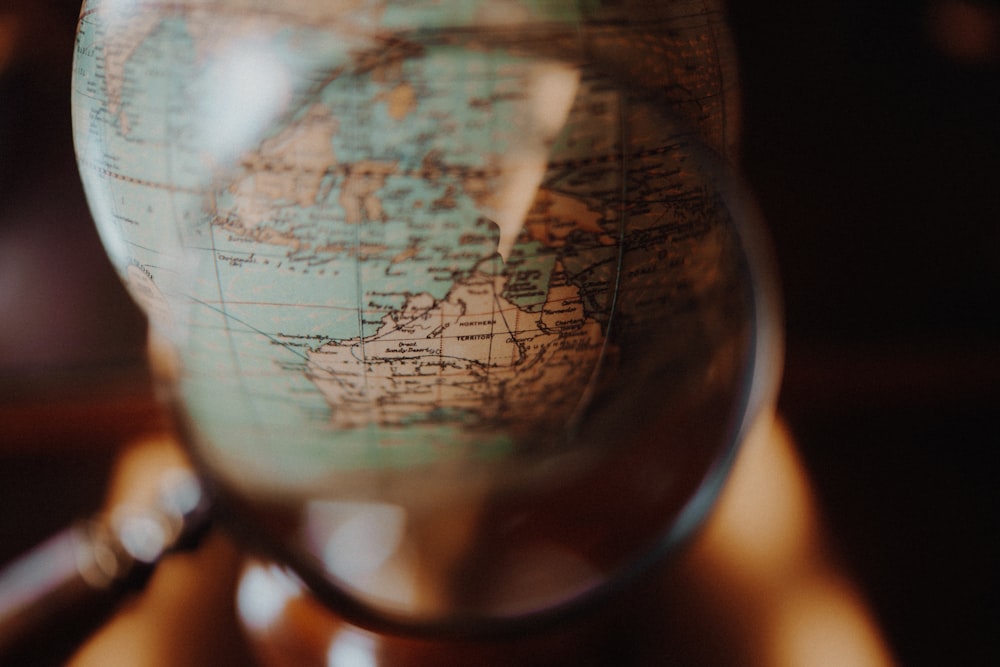 shallow focus photo of desk globe