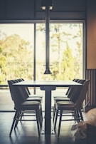 A dining area with a sleek table and comfortable chairs.