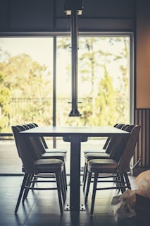 A dining area with a sleek table and comfortable chairs.