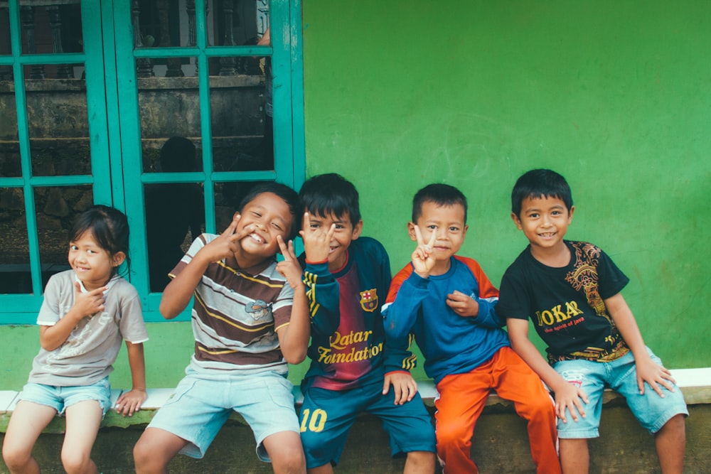 five toddlers near the window