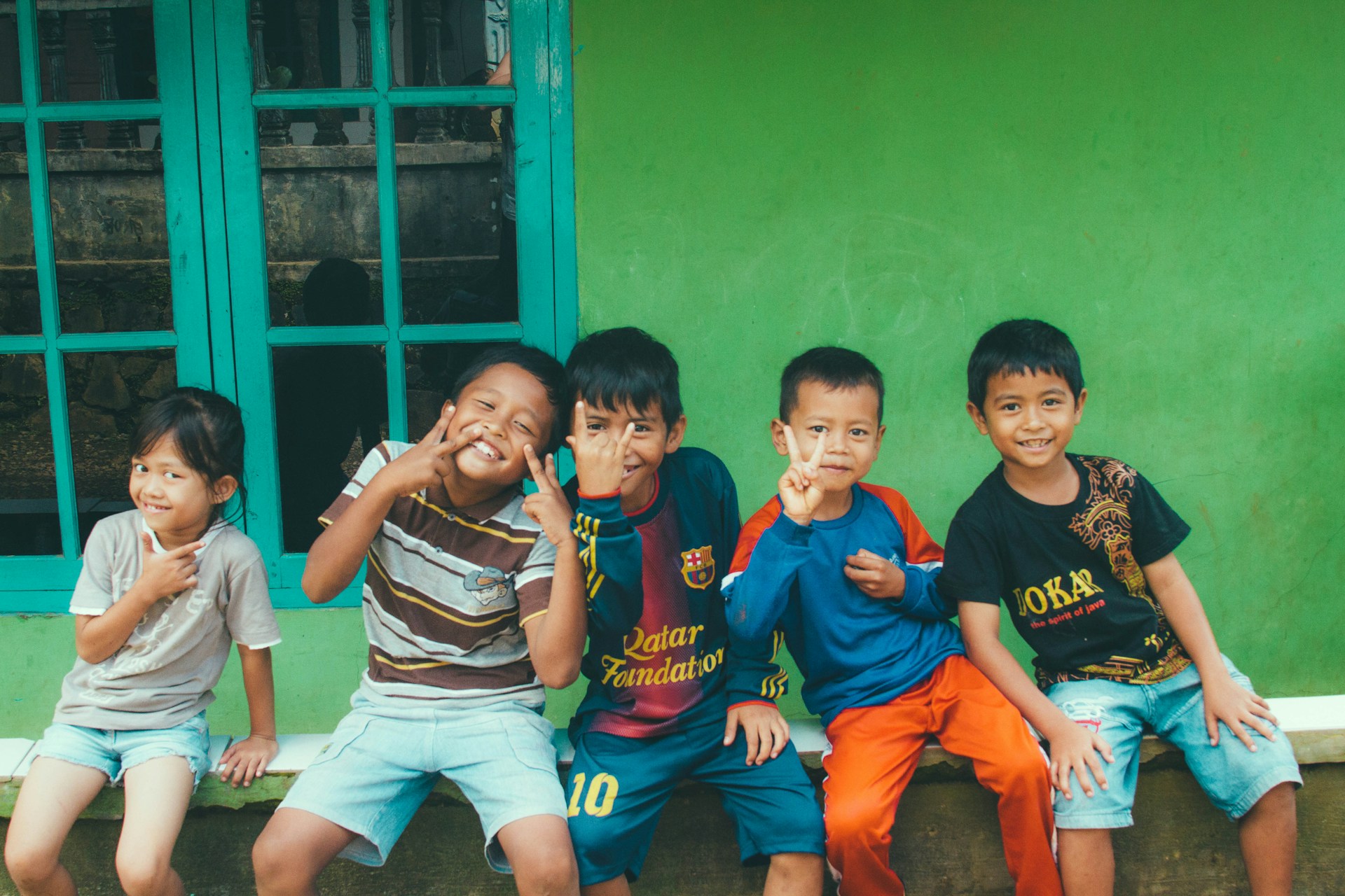 five toddlers near the window