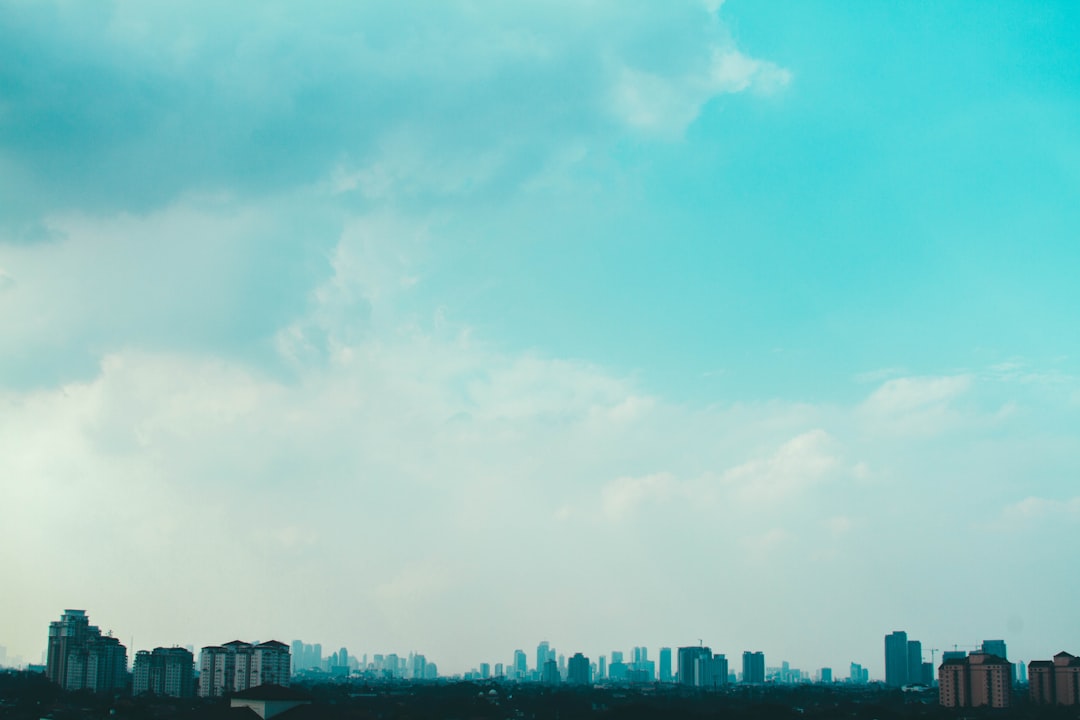 aerial photography of city with high-rise buildings under blue and white sky