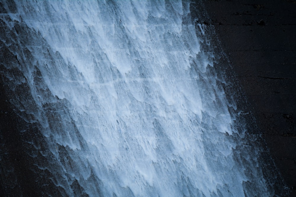 a man standing in front of a waterfall