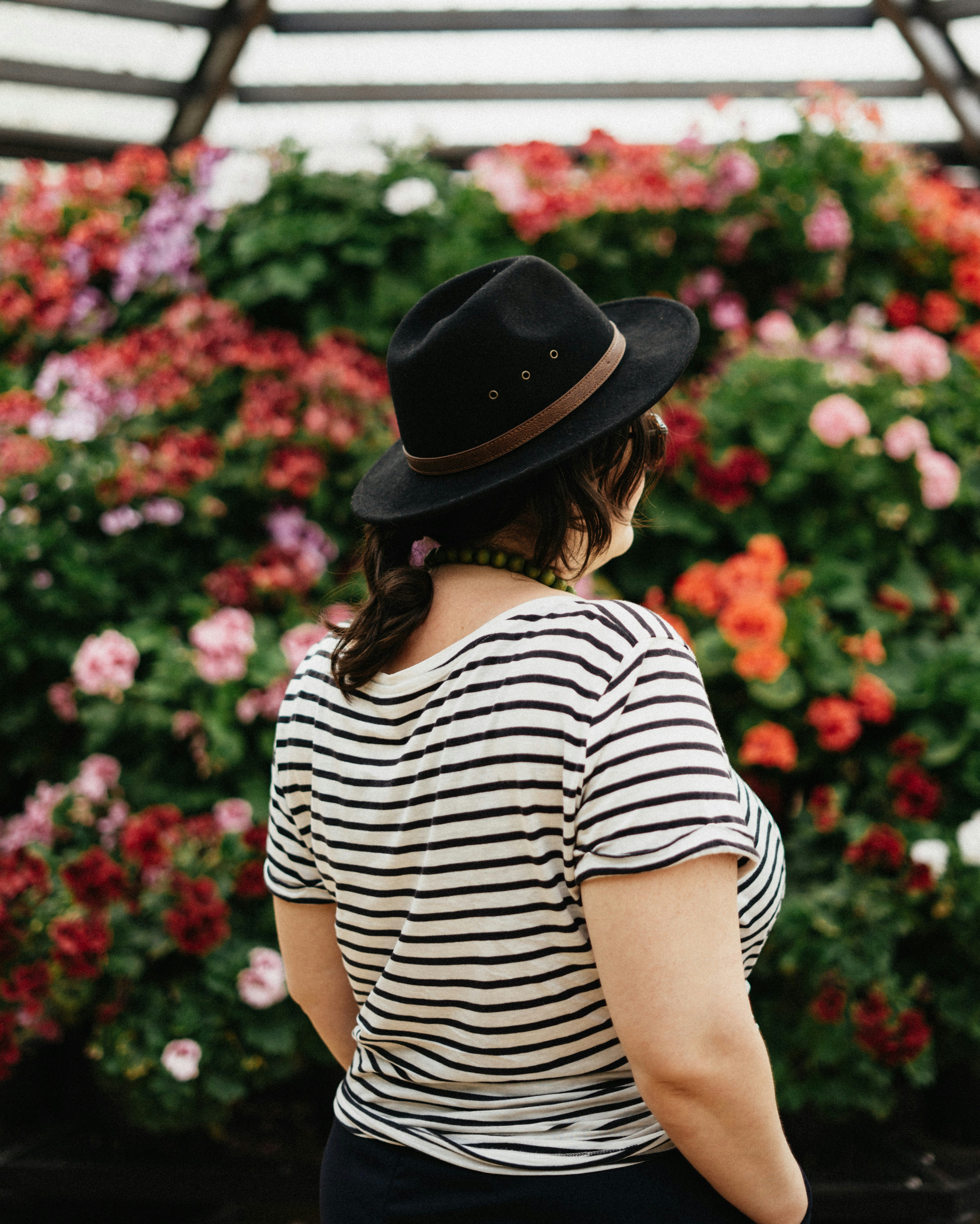 Foto de enfoque selectivo de mujer mirando en la flor