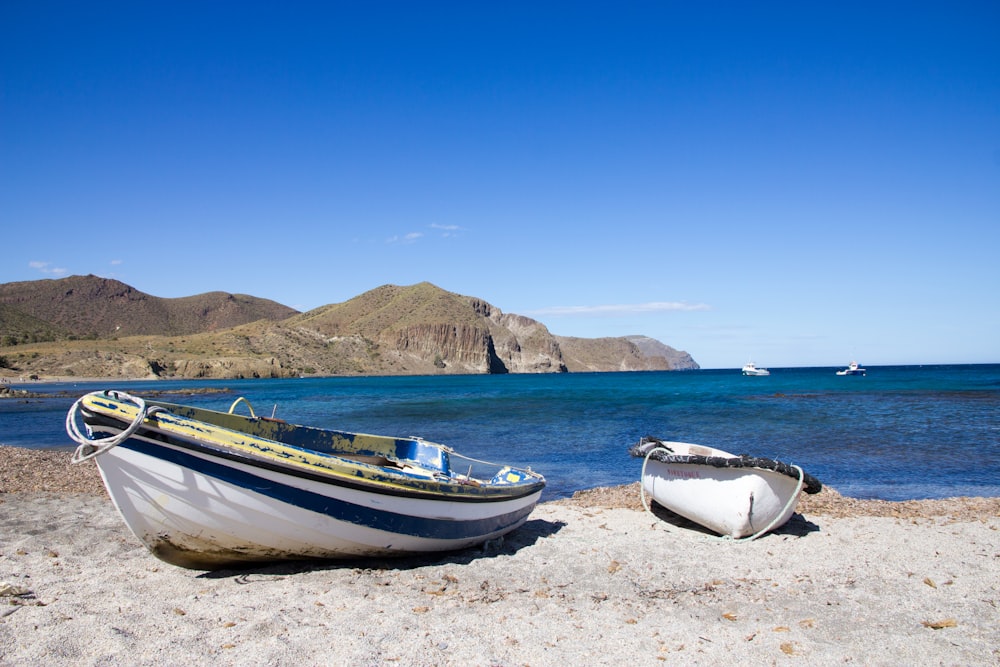 white canoes on shoreline