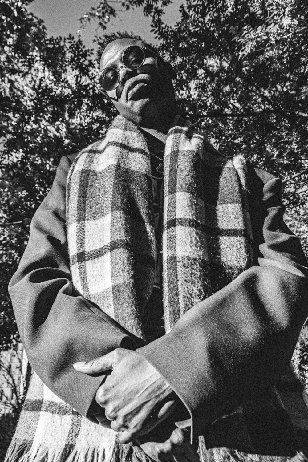 grayscale photography of man wearing coat and scarf