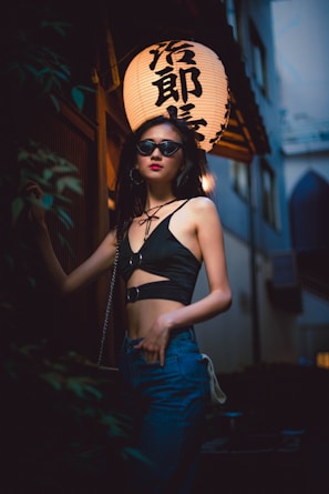 A candid shot of a woman in oversized streetwear, walking confidently through a city alley lit by neon lights.