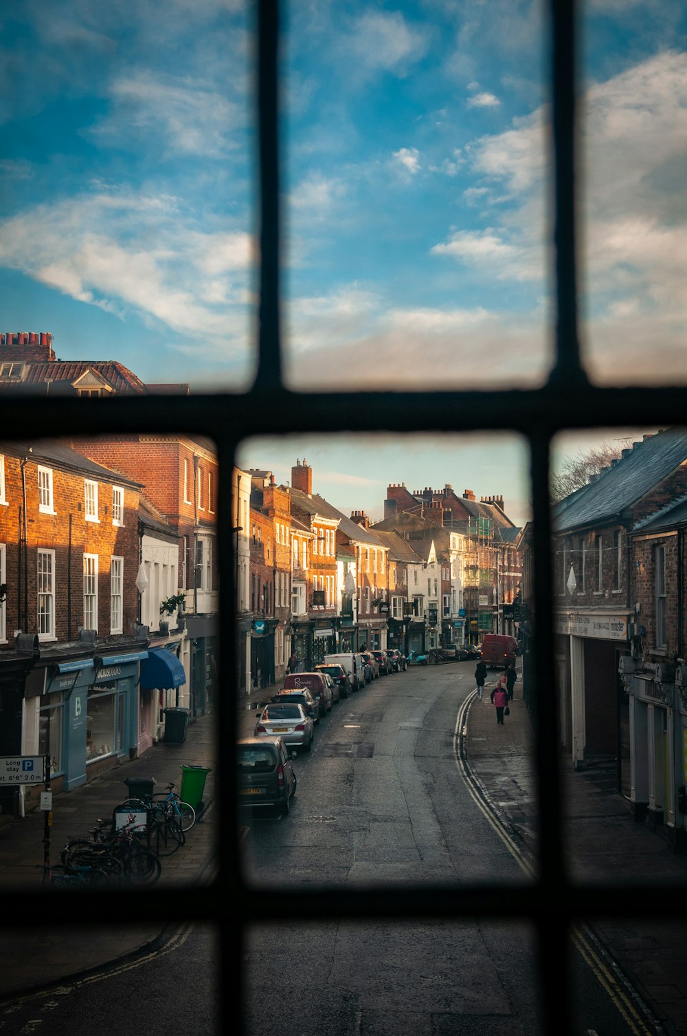 street between buildings through glass window