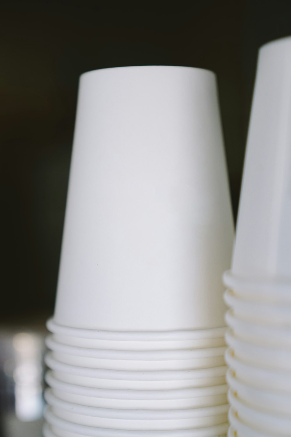 selective focus photography of white plastic cups