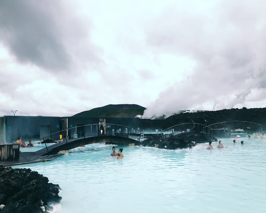 People bathing in Iceland’s Blue Lagoon geothermal spa among lava rock