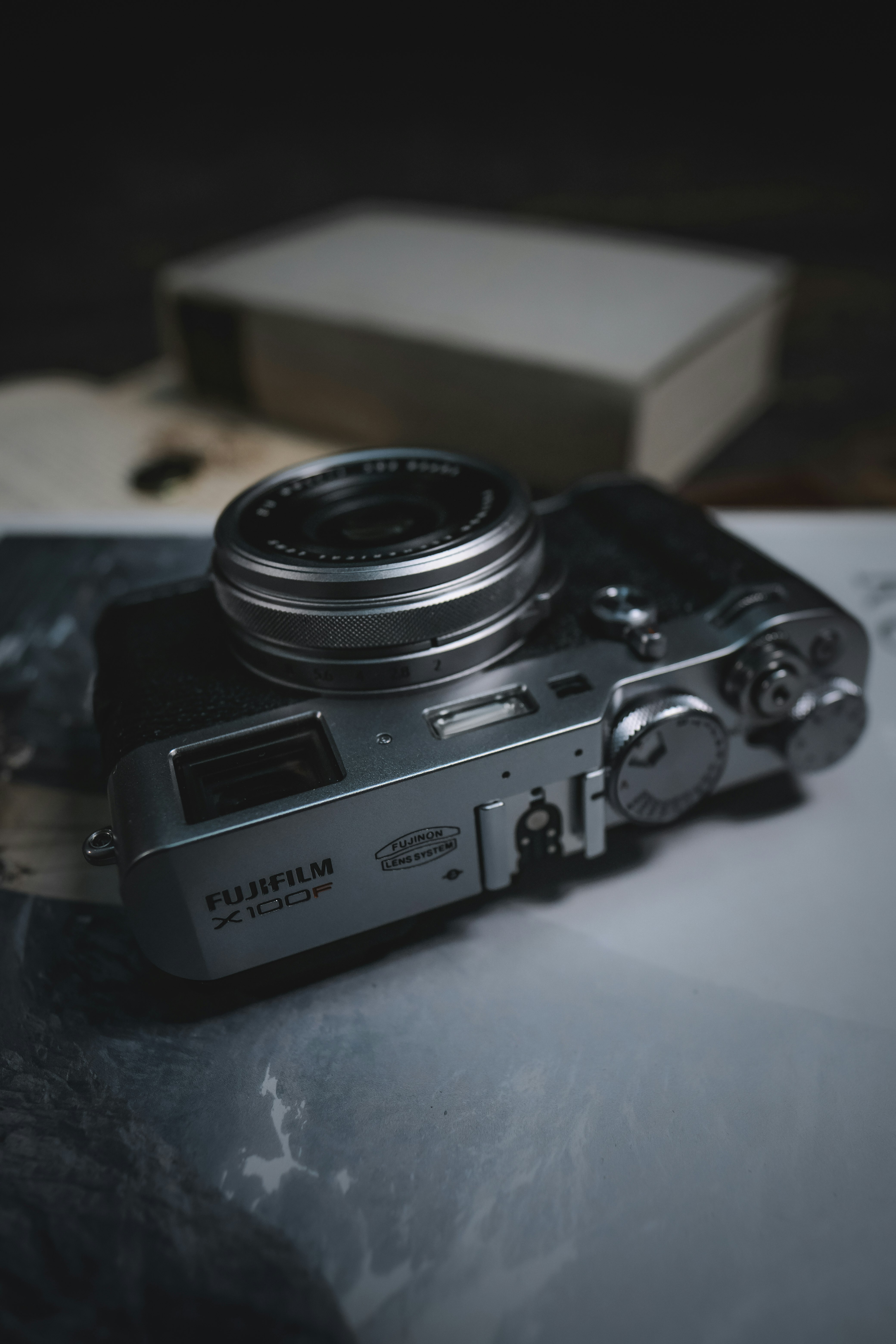 silver Fujifilm camera on white surface