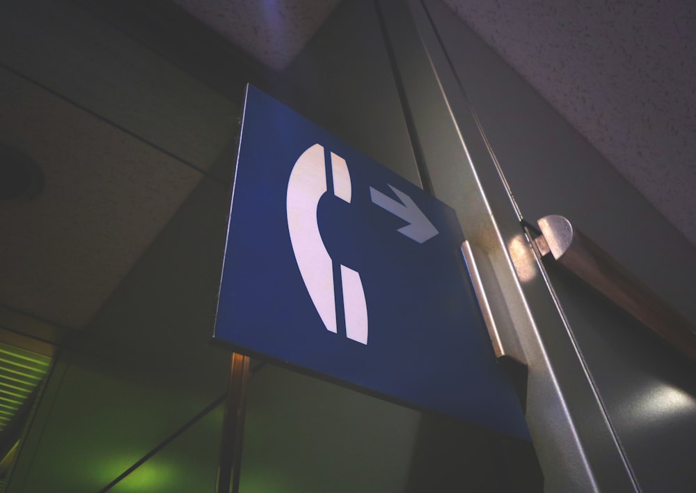 blue and white telephone sign