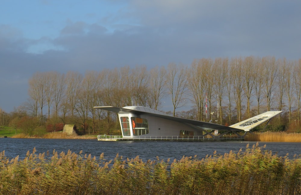 house beside body of water near trees